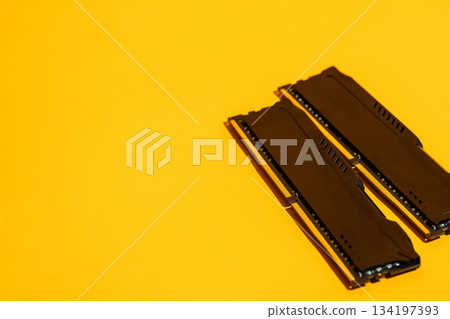 Two black RAM modules on yellow background with copy space Two black RAM modules on yellow background with copy space 134197393