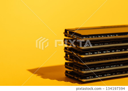 RAM modules stacked with strong shadow on yellow background RAM modules stacked with strong shadow on yellow background 134197394