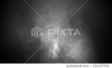Wisps of white smoke rising and swirling on a dark, gradient background, creating an atmospheric and mysterious foreground 134197795