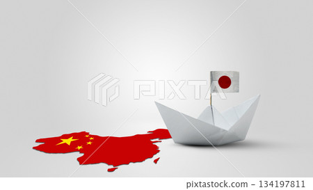 Paper boat with Japan national flag facing China maps. Conflict between China against Japan 134197811