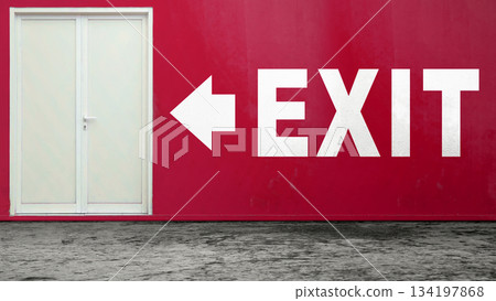 White exit sign with an arrow pointing left on a red wall, next to a double door. Concept of emergency exit, safety, escape, or direction 134197868