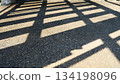 Rectangular Grid Shadows on Textured Concrete Ground in Bright Sunlight, abstract light and shadow background 134198096
