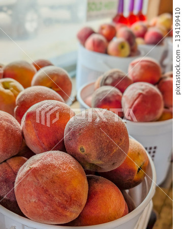Fresh peaches in baskets for sale at the farmers market Fresh peaches in baskets for sale at the farmers market 134199410