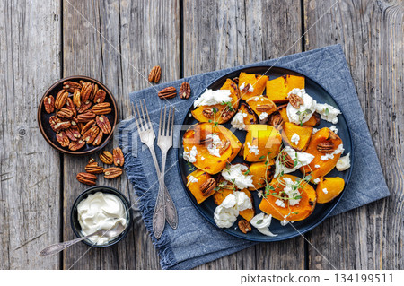 baked butternut squash with cheese, thyme, pecan 134199511