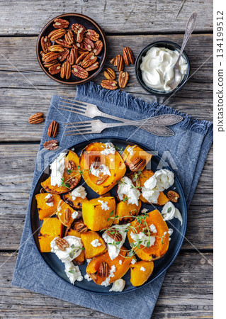 baked butternut squash with cheese, thyme, pecan 134199512
