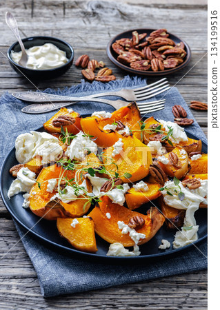 baked butternut squash with cheese, thyme, pecan 134199516