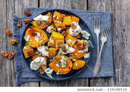 baked butternut squash with cheese, thyme, pecan baked butternut squash with cheese, thyme, pecan 134199518