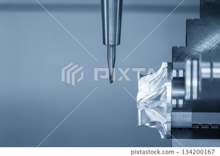 The 5-axis CNC milling machine cutting the automotive part with solid ball nose end mill tool in the blue scene tone. 134200167