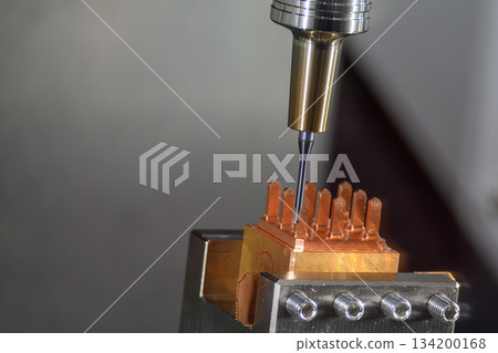 Close up scene the CNC milling machine cutting the copper electrode parts. 134200168