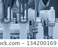 The empty healthcare bottles on the conveyor belt for filling process in blue tone scene. 134200169