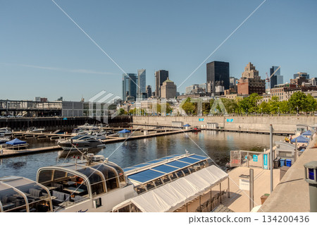 Montreal city skyline panorama over river in the day with urban buildings Montreal city skyline panorama over river in the day with urban buildings 134200436