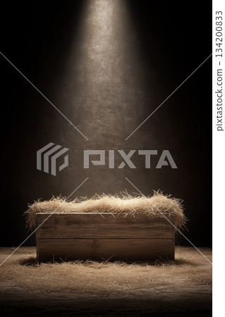 Wooden manger with straw under soft spot light. Empty wooden manger with straw receiving warm light, symbolizing birth and new beginnings 134200833