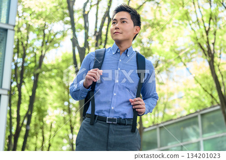 Refreshing businessman outdoors 134201023