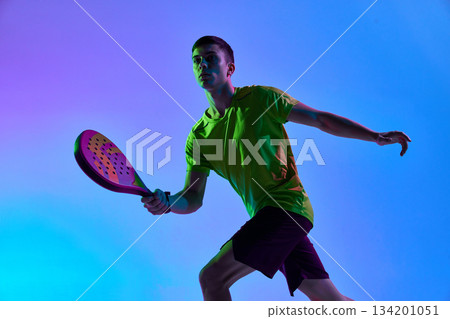 Padel player mid-stride neon gradient composition. 134201051