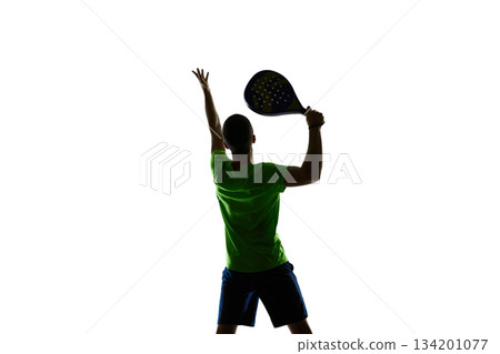 Padel athlete serve preparation silhouette with raised arm. Padel athlete serve preparation silhouette with raised arm. 134201077