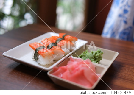 Salmon sushi nigiri with wasabi and pickled ginger, bright lighting, overhead composition on slate. Salmon sushi nigiri with wasabi and pickled ginger, bright lighting, overhead composition on slate. 134201429