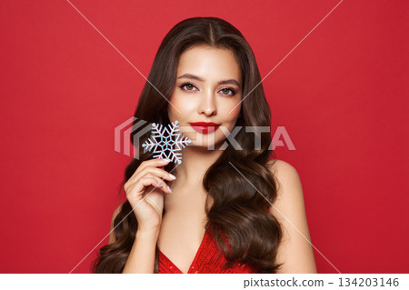 Beautiful young woman with glowing snowflake 134203146