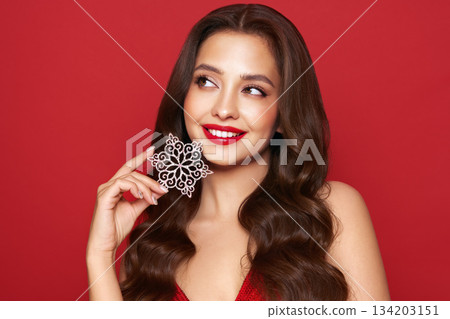 Beautiful young woman with glowing snowflake 134203151