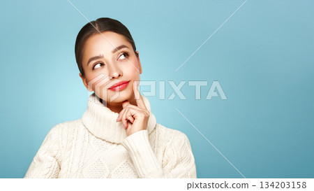 Young beautiful woman in a warm  white sweater 134203158