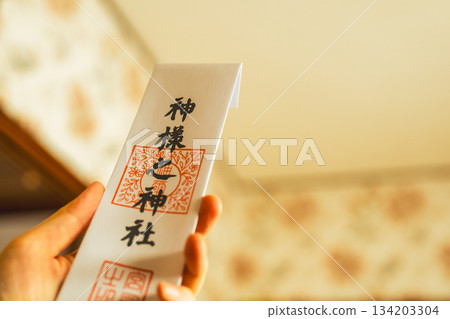 A sacred tablet held in hand and a warm light 134203304