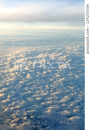 Vast expanse of fluffy white clouds seen from above during a flight Vast expanse of fluffy white clouds seen from above during a flight 134203504