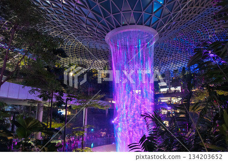 Night view of the Rain Vortex, an artificial waterfall at the Jewel complex at Singapore Changi International Airport 134203652