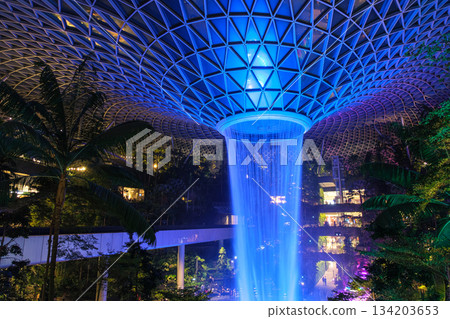 Night view of the Rain Vortex, an artificial waterfall at the Jewel complex at Singapore Changi International Airport 134203653