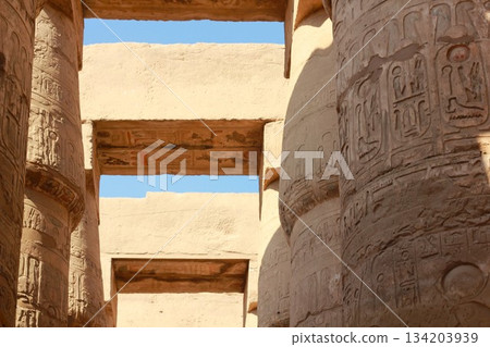 Ancient egyptian temple columns with hieroglyphic carvings. Karnak temple in Luxor, Egypt Ancient egyptian temple columns with hieroglyphic carvings. Karnak temple in Luxor, Egypt 134203939