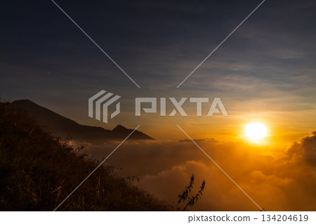 Sunrise over the mountain with expanse of clouds on Mount Anak Dara, Lombok, Indonesia Sunrise over the mountain with expanse of clouds on Mount Anak Dara, Lombok, Indonesia 134204619