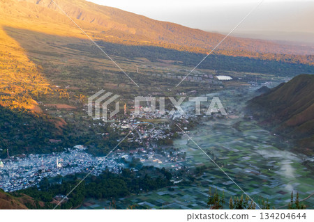 Sembalun Valley Village and rice fields under mist at sunrise. Sembalun Valley Village and rice fields under mist at sunrise. 134204644