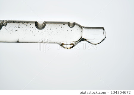 Cosmetic pipette dropping transparent serum for skincare routine 134204672
