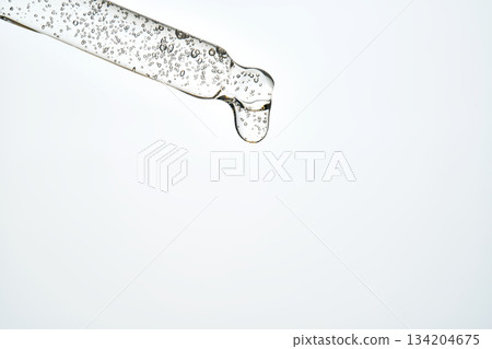 Cosmetic pipette dispensing serum drop for skincare routine 134204675