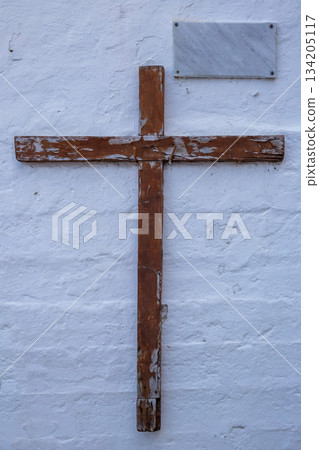 White textured wall and wooden cross, Spain 134205117
