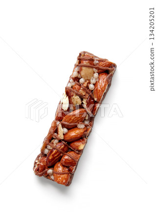 Sweet nutty caramel bar with puffed rice on a white background. Sweet nutty caramel bar with puffed rice on a white background. 134205201