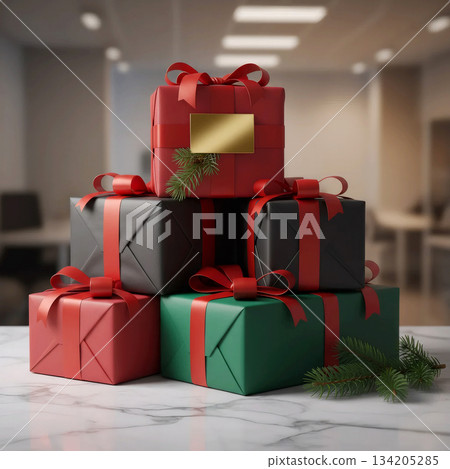 stack of new year gifts in red, black, and green wrapping with a golden tag on an office desk 134205285