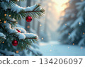 Red christmas baubles hanging from a snow covered pine tree branch in a snowy forest 134206097