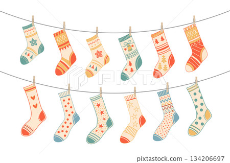 Festive Christmas stockings hanging on a clothesline. Socks with various traditional colorful holiday ornaments. 134206697