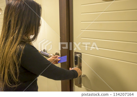 Person using a keycard to unlock a modern door, key electronic lock, hotel room, holidays in mallorca, spain Person using a keycard to unlock a modern door, key electronic lock, hotel room, holidays in mallorca, spain 134207164