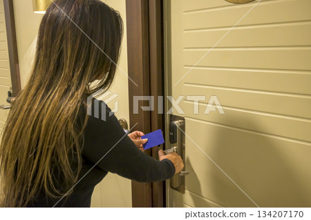 Person using a keycard to unlock a modern door, key electronic lock, hotel room, holidays in mallorca, spain Person using a keycard to unlock a modern door, key electronic lock, hotel room, holidays in mallorca, spain 134207170