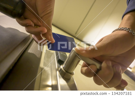 A hand inserting a blue card key into a modern hotel door lock, key electronic lock, hotel room, holidays in mallorca, spain 134207181