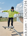 young, teenager, with skateboard, jumping, on the track, with headphones, 134207194