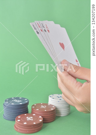 poker player with cards on green table poker player with cards on green table 134207199