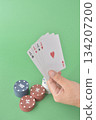 hand playing cards on green table 134207200