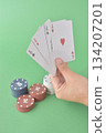 hand playing cards on green table 134207201