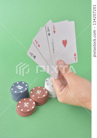 hand playing cards on green table hand playing cards on green table 134207201