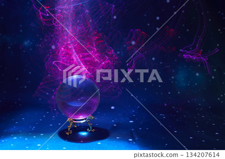 Mystical Crystal Sphere. A glowing crystal ball with swirling pink and blue lights evokes magic and mystery. Mystical Crystal Sphere. A glowing crystal ball with swirling pink and blue lights evokes magic and mystery. 134207614