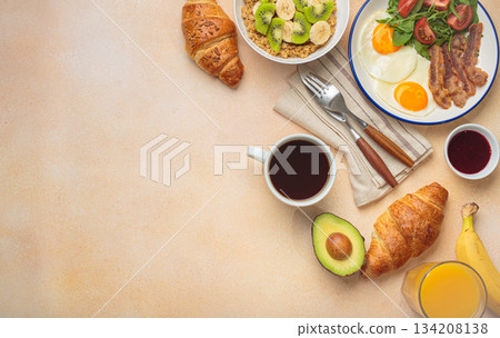 Breakfast warm beige background eggs vegetables salad, oats fruit, croissants, coffee, juice healthy morning. 134208138