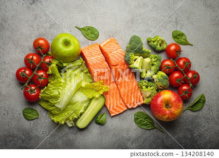 Fresh raw healthy food vegetables fruit salmon fillet grey background, inflammatory diet, clean eating Fresh raw healthy food vegetables fruit salmon fillet grey background, inflammatory diet, clean eating 134208140