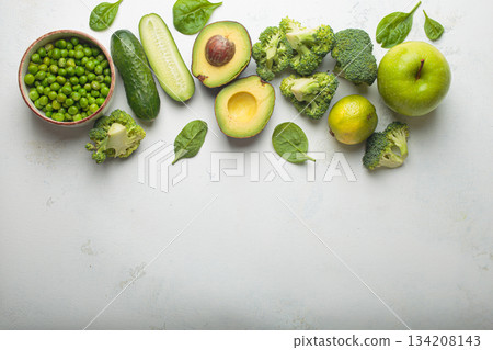 Fresh green vegetables and fruit white background top view, diet, vegetarian healthy food copy space Fresh green vegetables and fruit white background top view, diet, vegetarian healthy food copy space 134208143