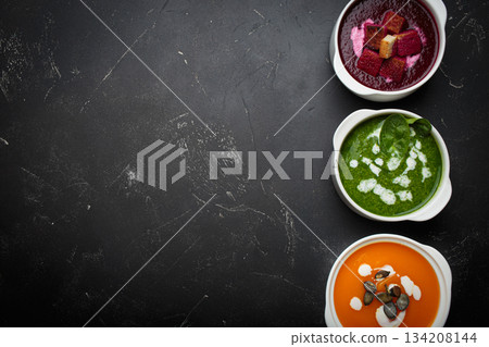 Three bowls colourful vegetable soups black background healthy diet cooking detox copy space 134208144